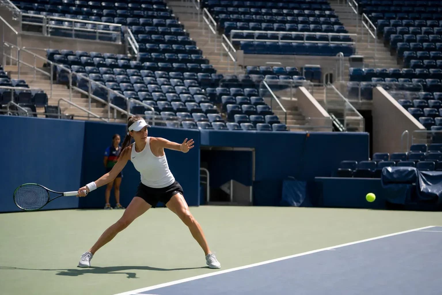 Female tennis player hitting a ball on court Female tennis player hitting a ball on court