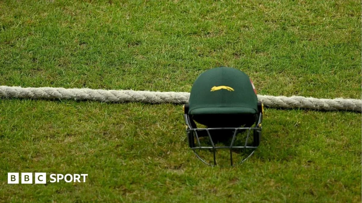 Cricket helmet placed on grass near boundary rope Cricket helmet placed on grass near boundary rope
