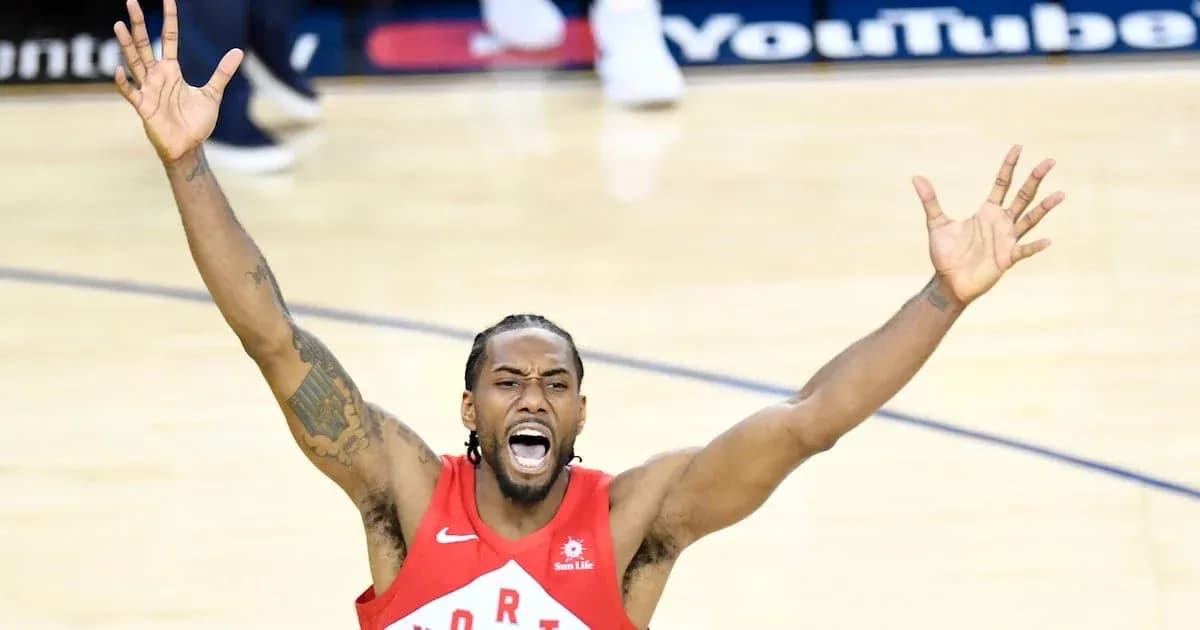 Player celebrating with arms raised during game Player celebrating with arms raised during game