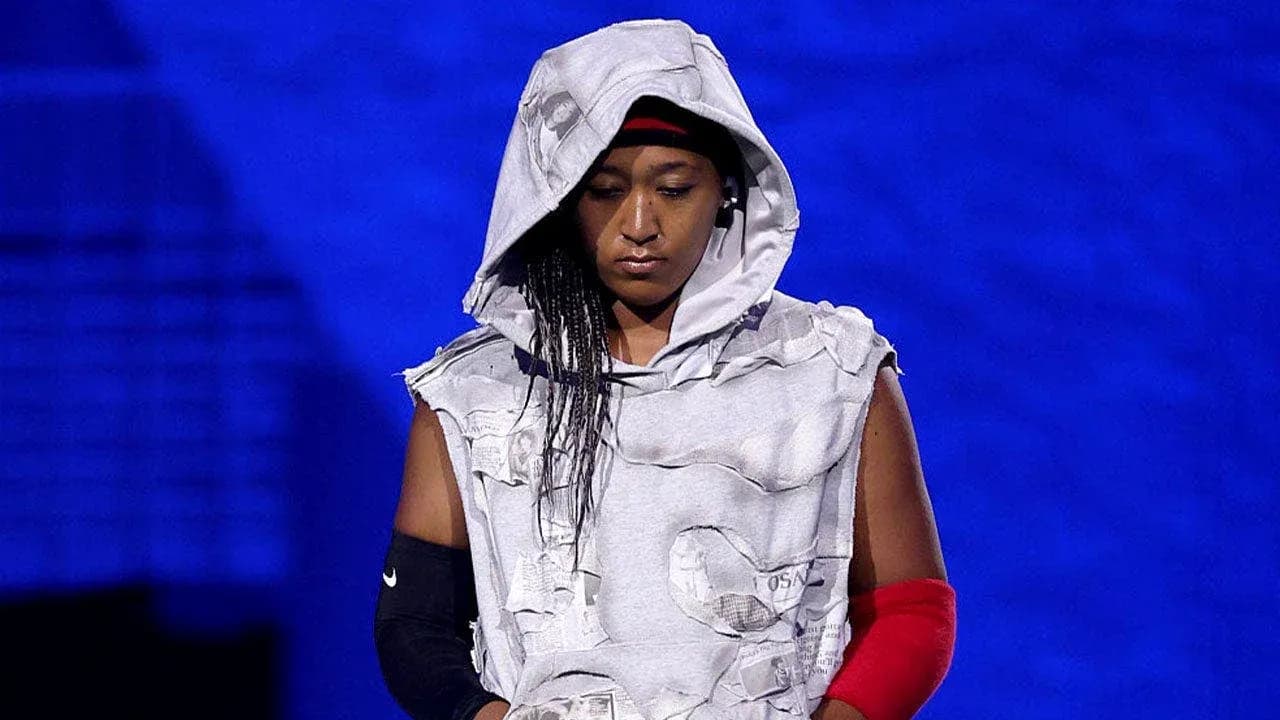 Athlete wearing a unique outfit on stage Athlete wearing a unique outfit on stage