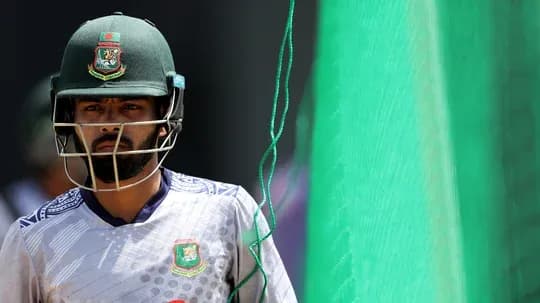 Cricketer in helmet walking towards practice net Cricketer in helmet walking towards practice net