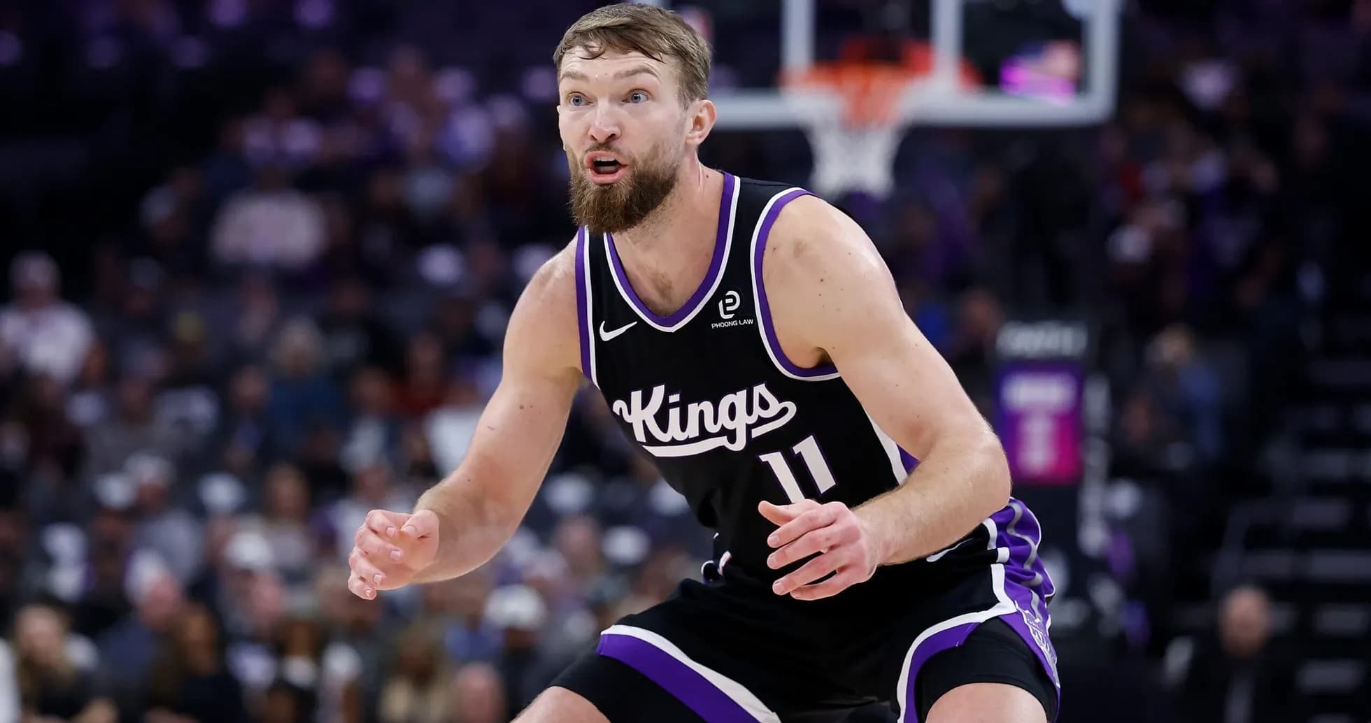 Player in black Kings uniform on defense during game Player in black Kings uniform on defense during game