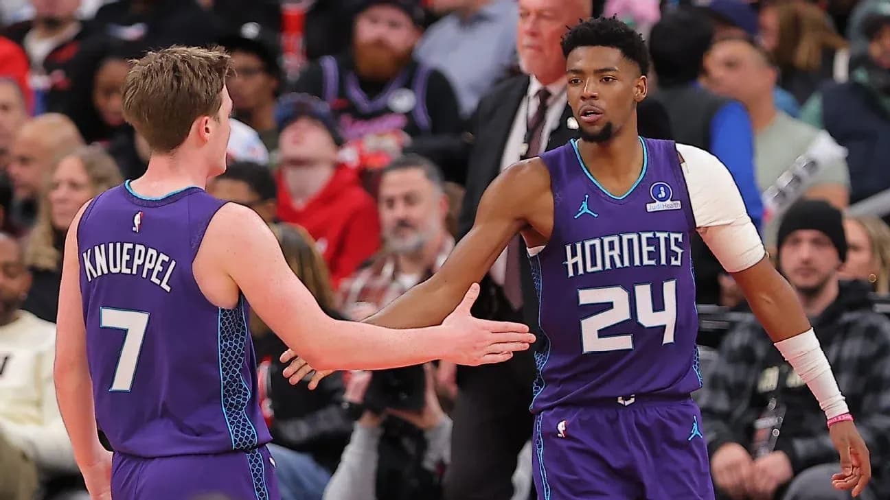 Two Hornets players greeting each other during game Two Hornets players greeting each other during game