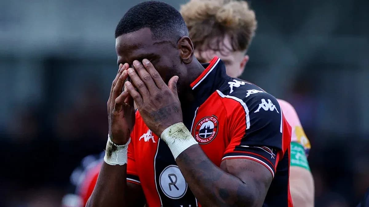 Player holding head in disappointment on the field Player holding head in disappointment on the field