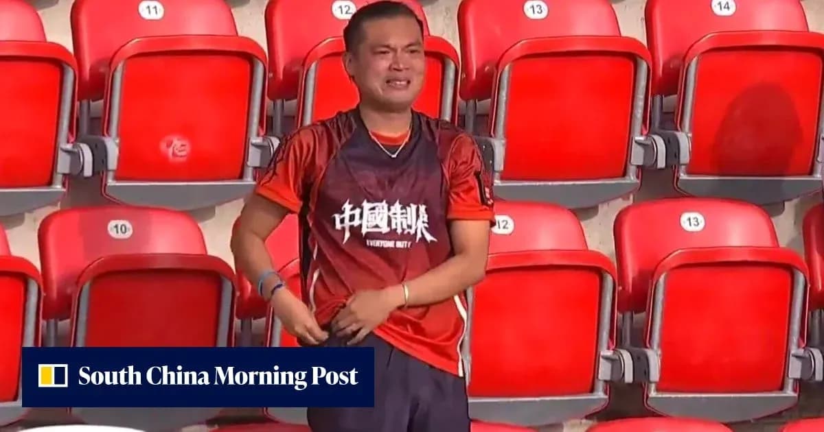 Fan in red shirt standing alone in stadium seats Fan in red shirt standing alone in stadium seats