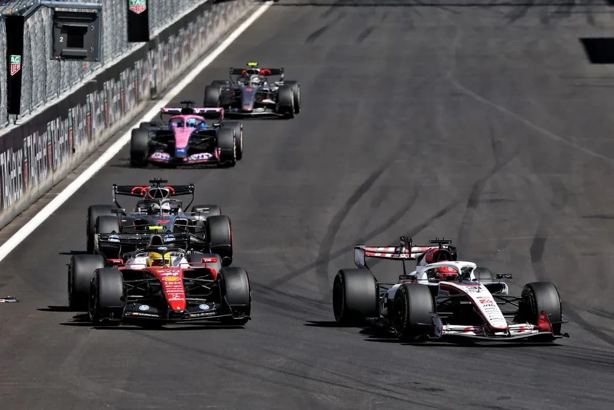 Four Formula 1 cars racing on track Four Formula 1 cars racing on track