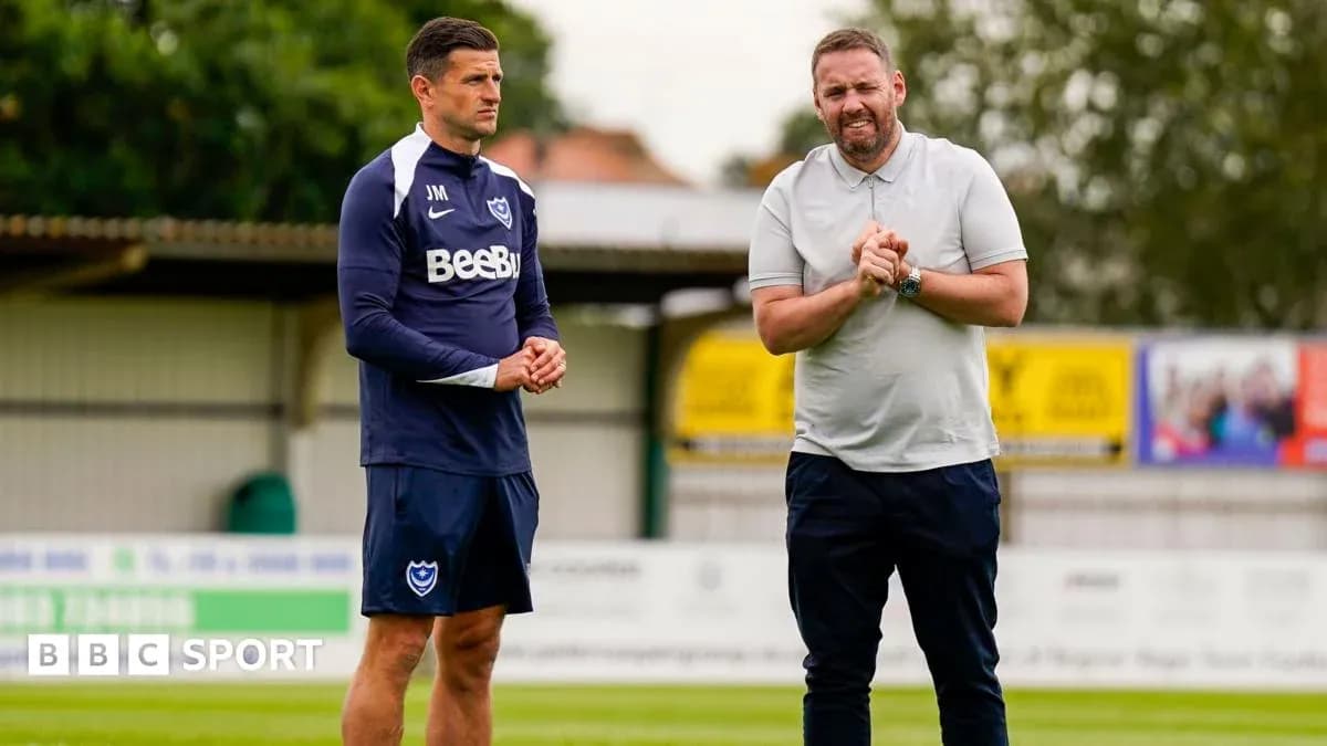 Two coaches discussing on training ground Two coaches discussing on training ground