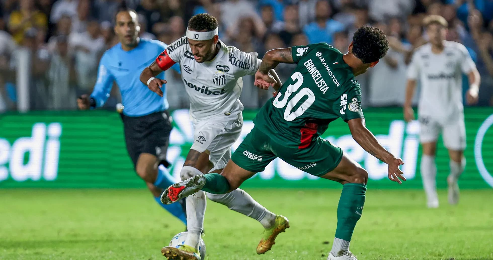 Player in white dribbling past defender in green Player in white dribbling past defender in green