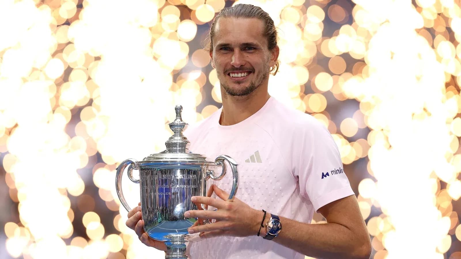 Player holding trophy with fireworks in background Player holding trophy with fireworks in background