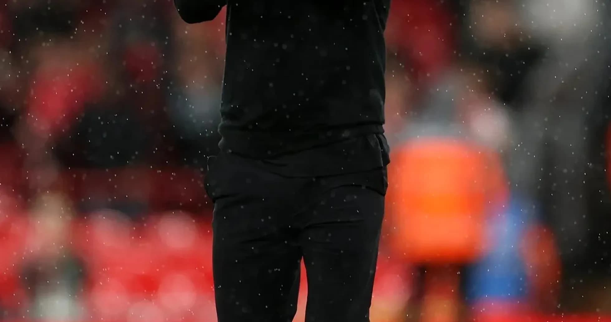 Coach clapping on the pitch during rain Coach clapping on the pitch during rain