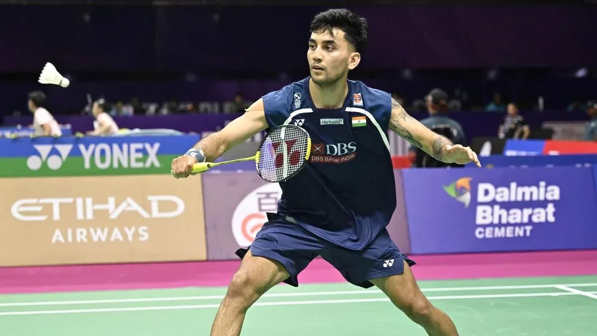 Player hitting shuttlecock during badminton match Player hitting shuttlecock during badminton match