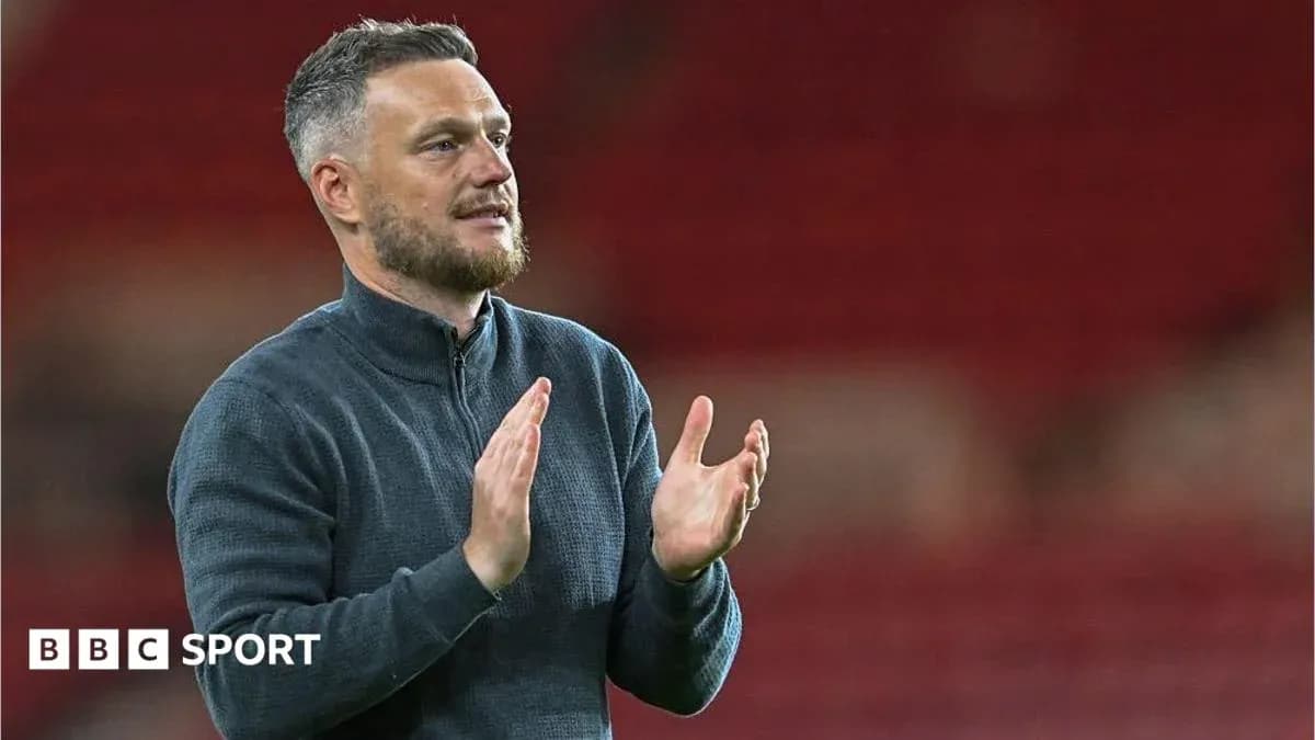Coach applauding in a stadium setting Coach applauding in a stadium setting