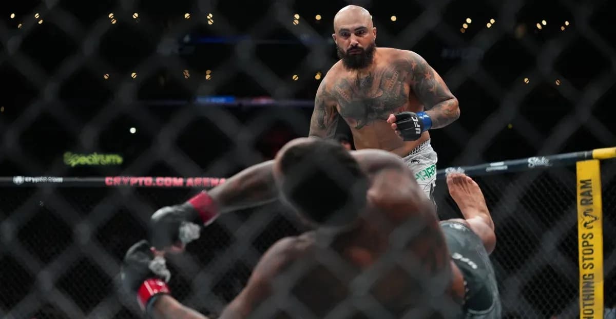 Fighter stands over opponent on the mat Fighter stands over opponent on the mat