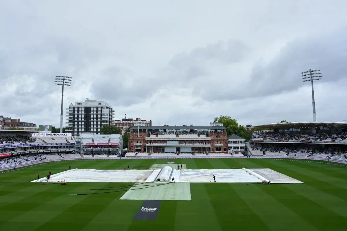 Ground staff covering pitch with tarpaulin at Lord's Ground staff covering pitch with tarpaulin at Lord's