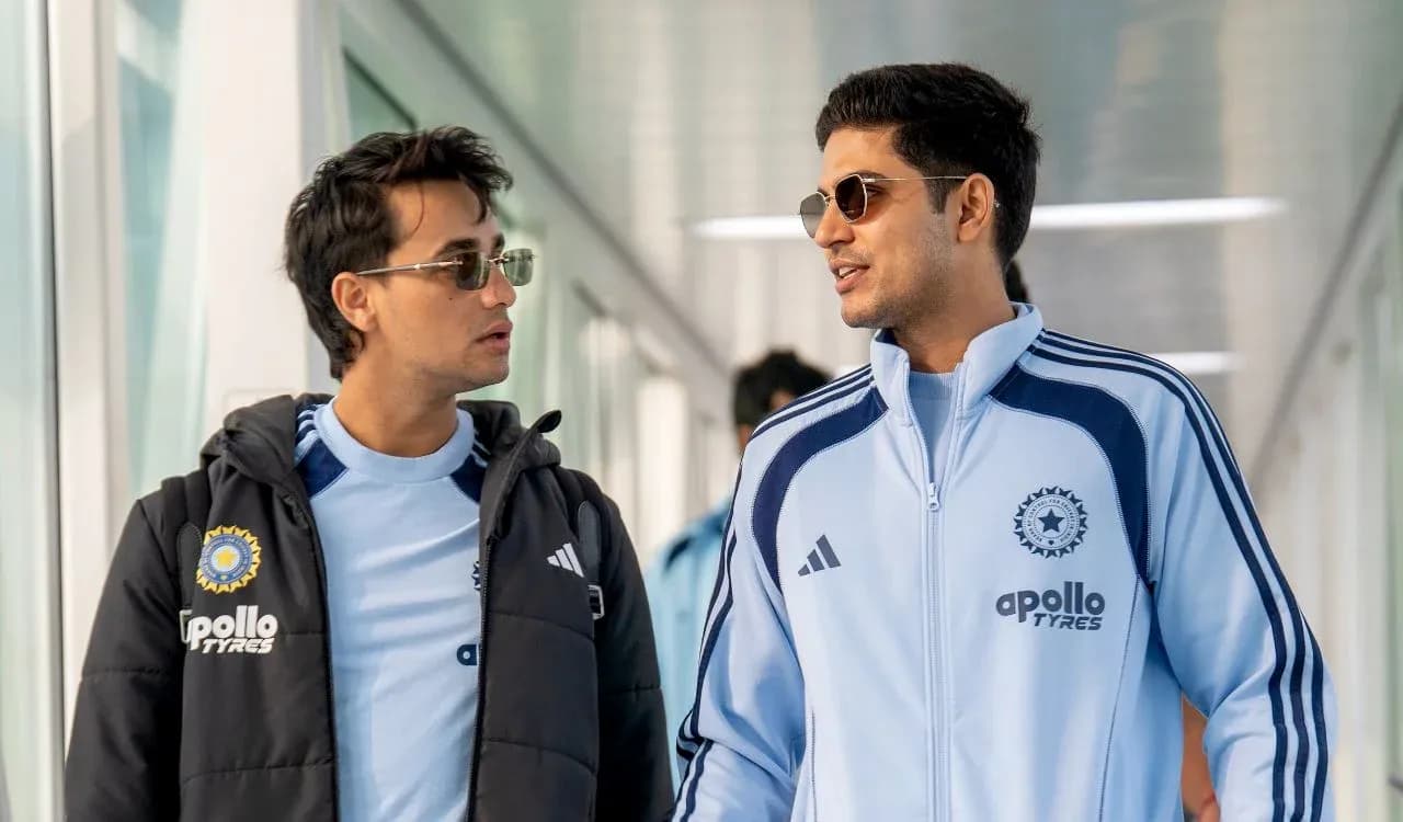 Two players in training jackets walking together Two players in training jackets walking together