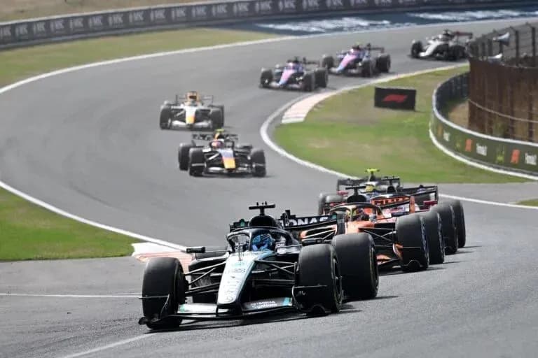 Formula 1 cars racing on a curved track Formula 1 cars racing on a curved track