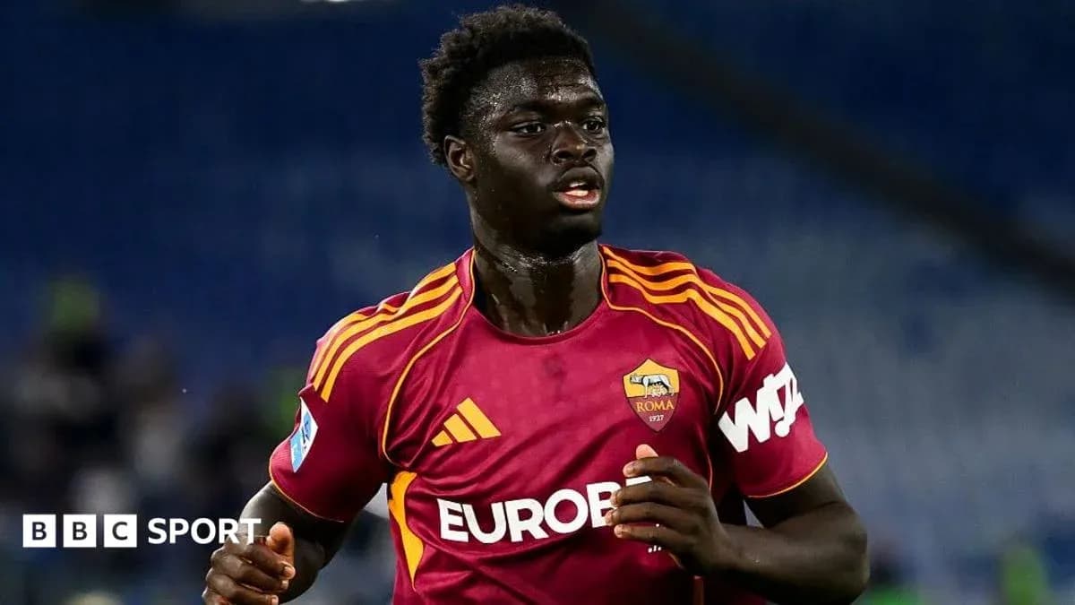 Player in AS Roma kit running on the field Player in AS Roma kit running on the field