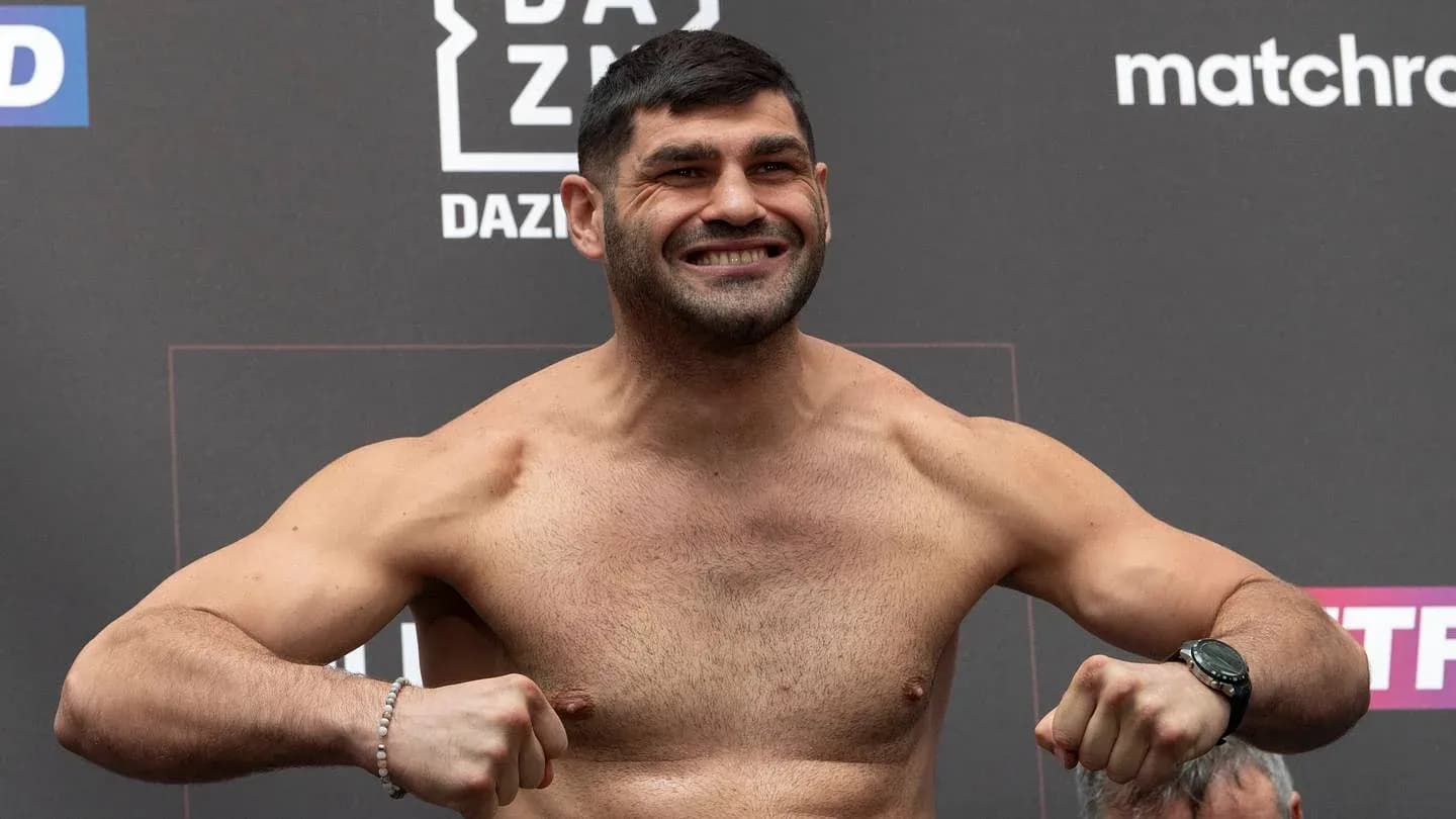 Fighter posing during weigh-in event with backdrop Fighter posing during weigh-in event with backdrop
