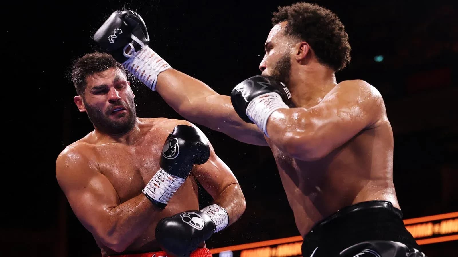 Boxers exchanging punches during a boxing match Boxers exchanging punches during a boxing match