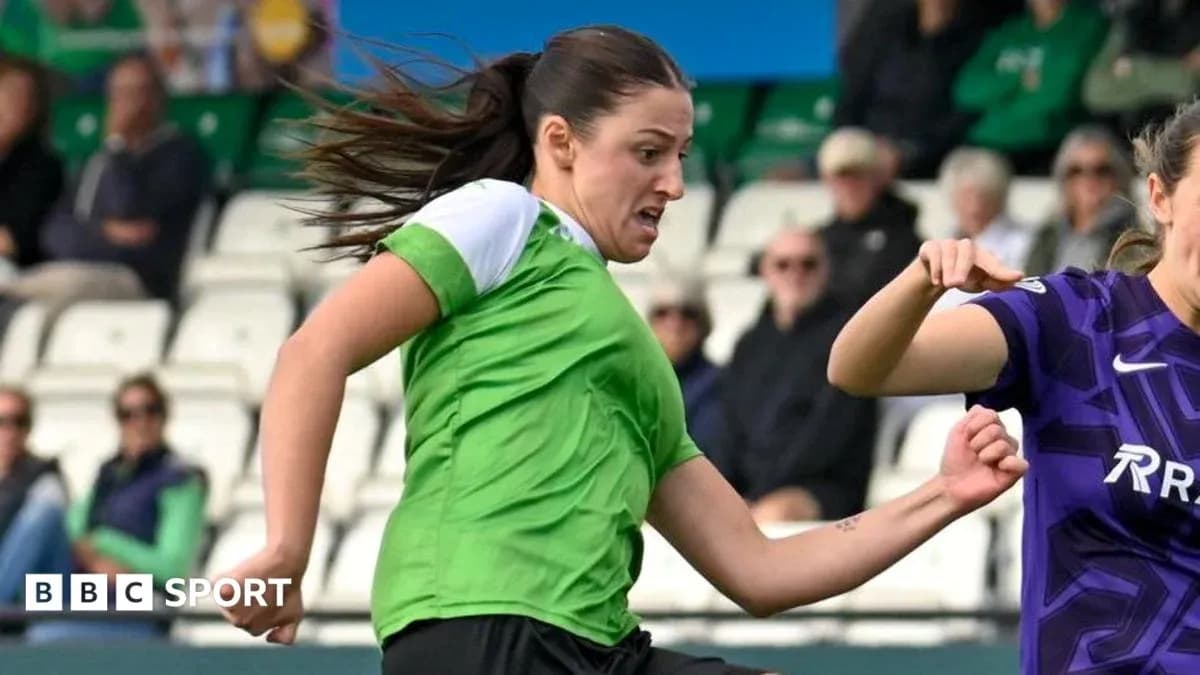 Player in green shirt dribbling past opponent Player in green shirt dribbling past opponent