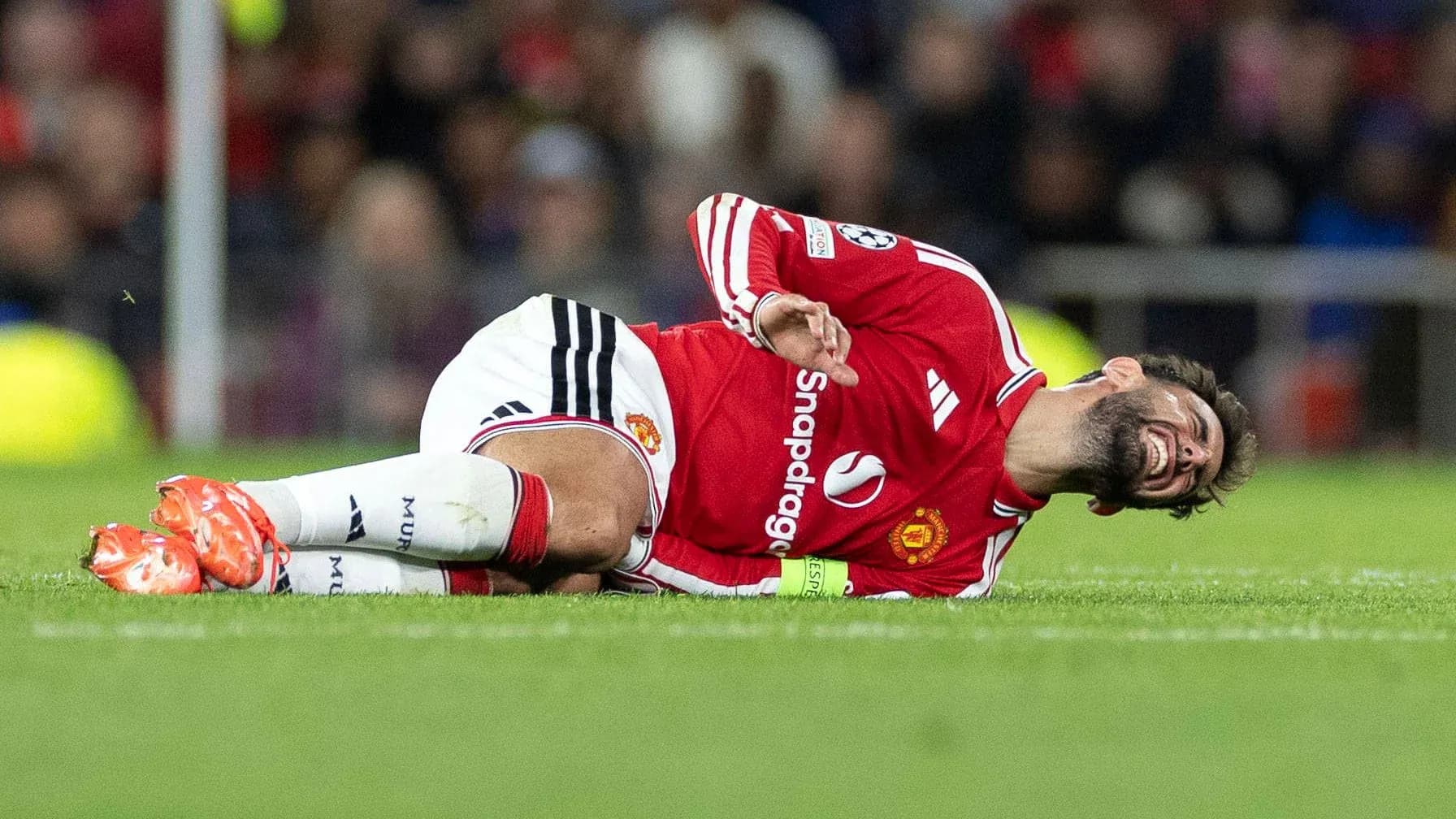 Player from Manchester United lying on pitch injured Player from Manchester United lying on pitch injured