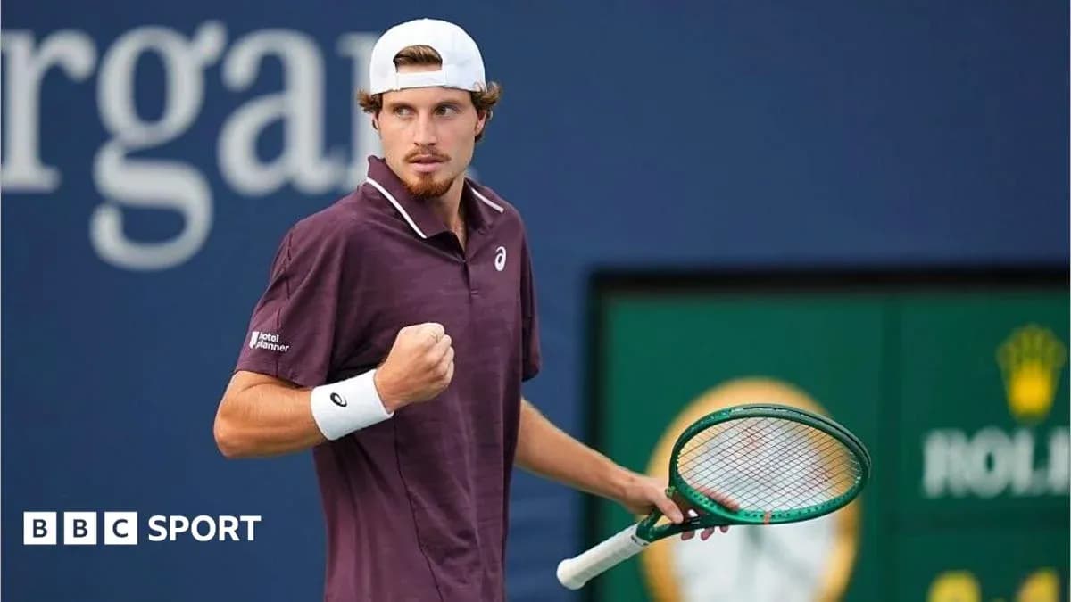 Tennis player celebrating with racquet at tournament Tennis player celebrating with racquet at tournament