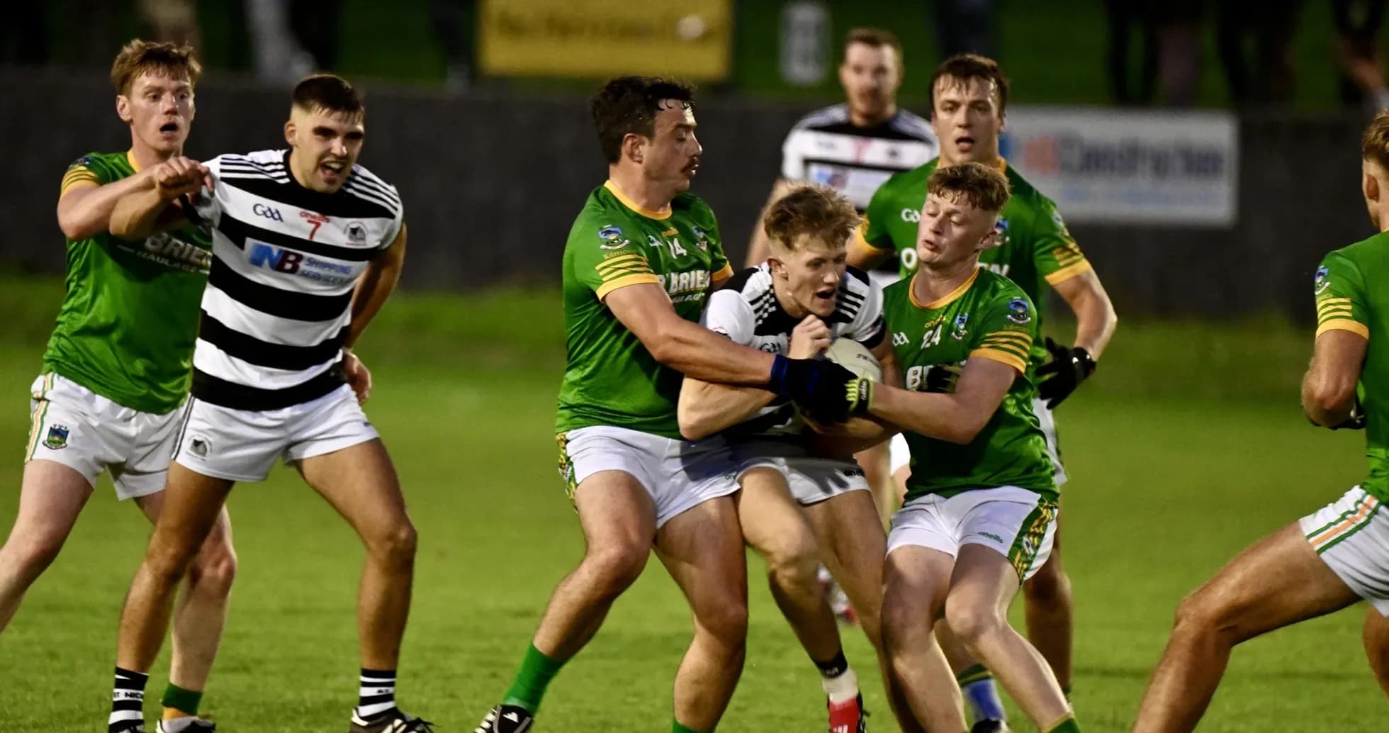 Players competing for the ball during a Gaelic football match Players competing for the ball during a Gaelic football match
