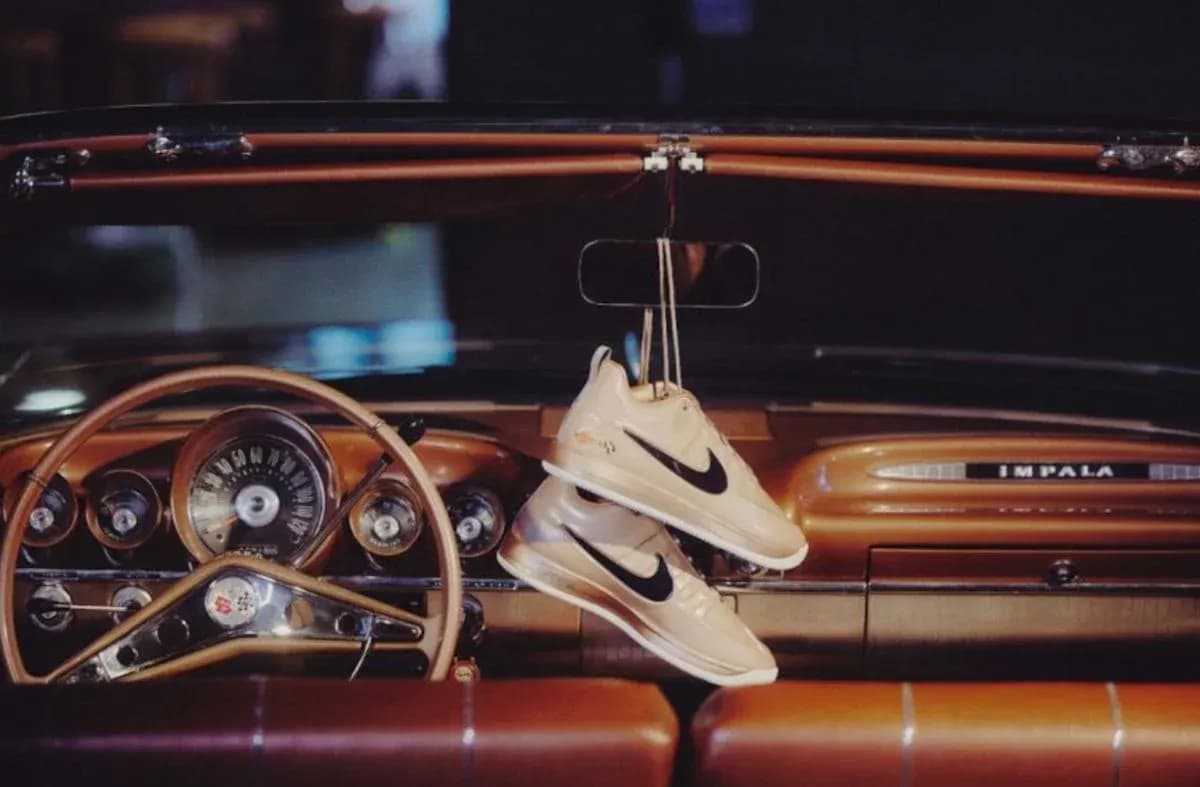 Nike sneakers hanging from classic car dashboard Nike sneakers hanging from classic car dashboard