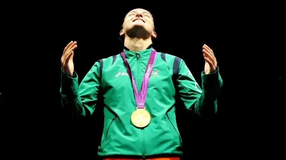 Athlete celebrating with gold medal at ceremony Athlete celebrating with gold medal at ceremony