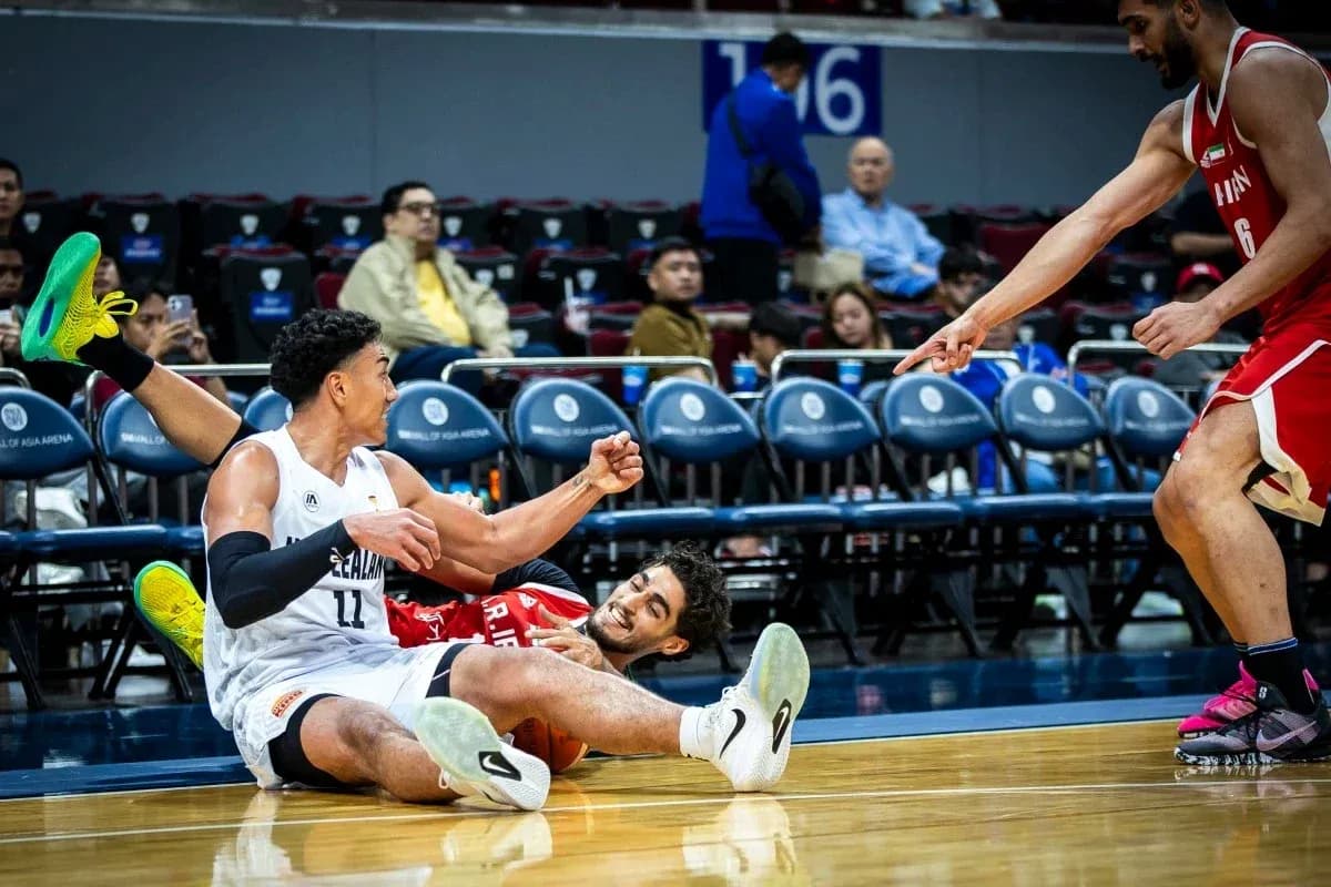Two basketball players on the court after falling Two basketball players on the court after falling