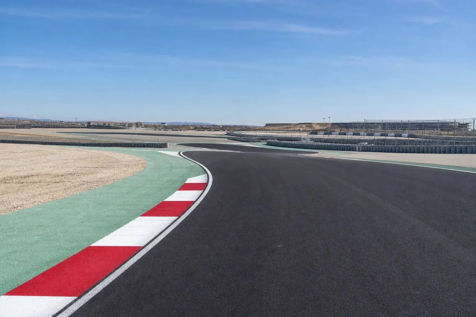 Curved racetrack with red and white curbing Curved racetrack with red and white curbing