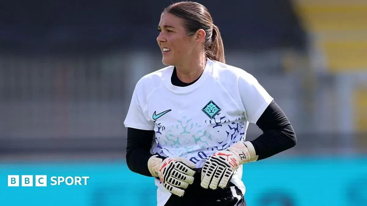Goalkeeper in training with gloves on pitch Goalkeeper in training with gloves on pitch
