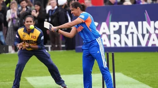 Female cricketer batting with bowler in background Female cricketer batting with bowler in background
