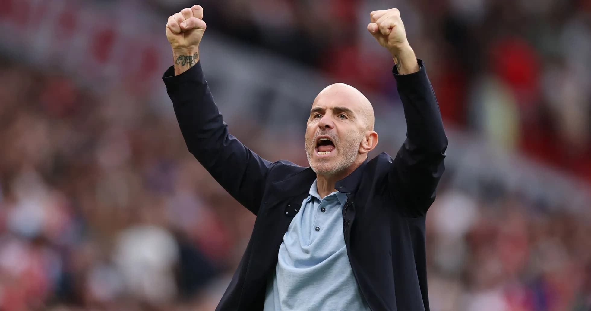 Coach celebrating with raised fists during match Coach celebrating with raised fists during match