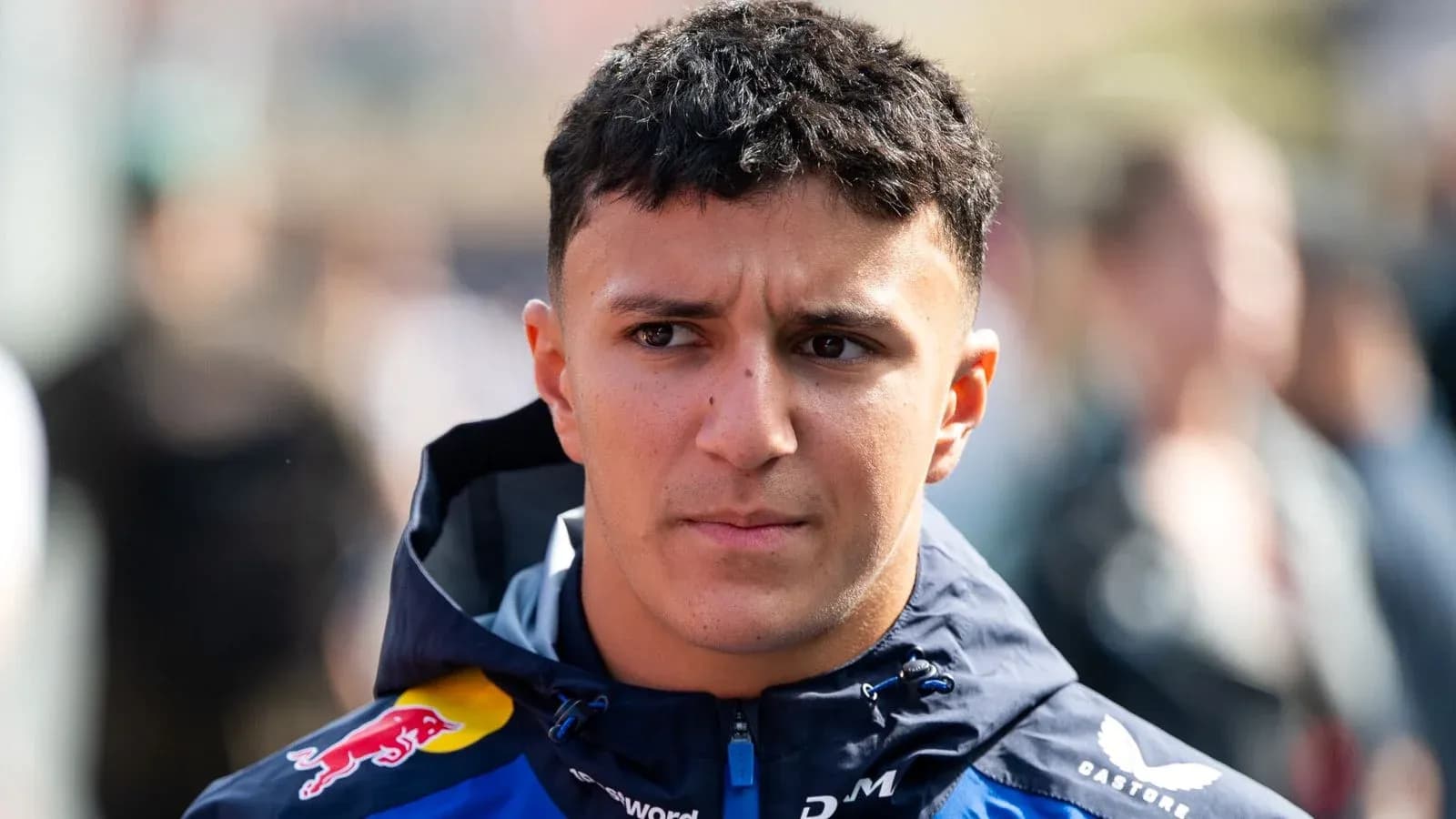 Driver wearing Red Bull jacket in paddock area Driver wearing Red Bull jacket in paddock area