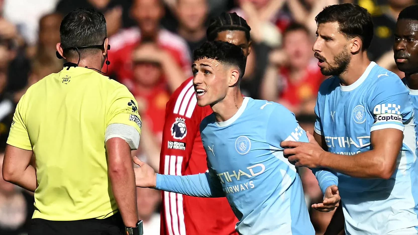 Manchester City players arguing with referee during match Manchester City players arguing with referee during match