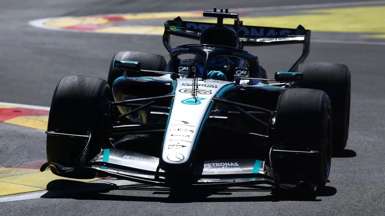 Mercedes Formula 1 car navigating a track corner Mercedes Formula 1 car navigating a track corner