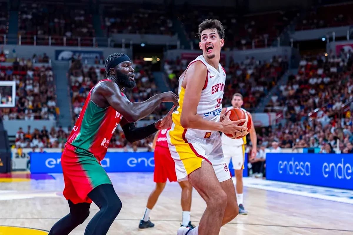 Spanish player holding basketball while being guarded Spanish player holding basketball while being guarded