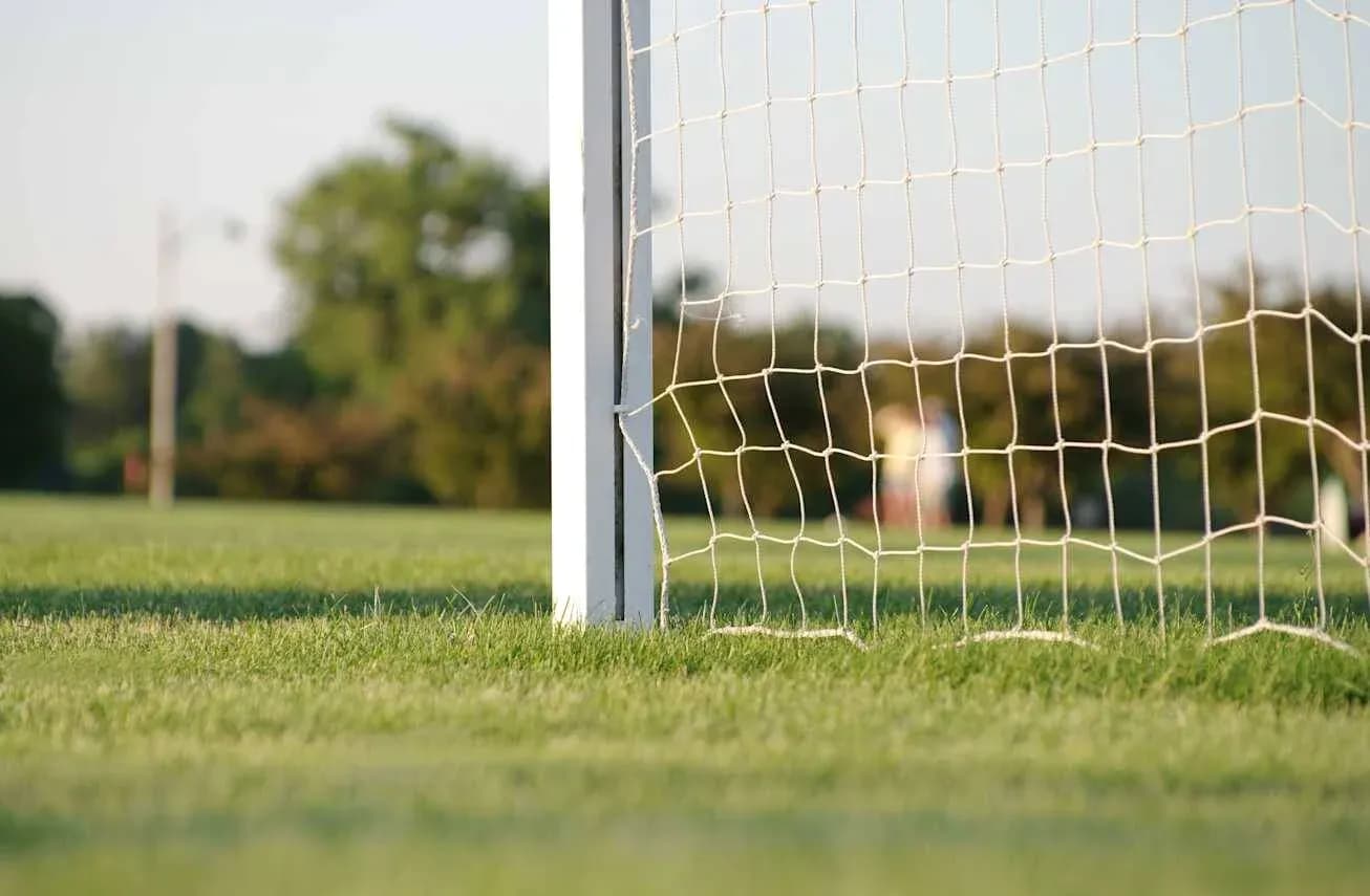 Close-up of soccer goal and net on field Close-up of soccer goal and net on field
