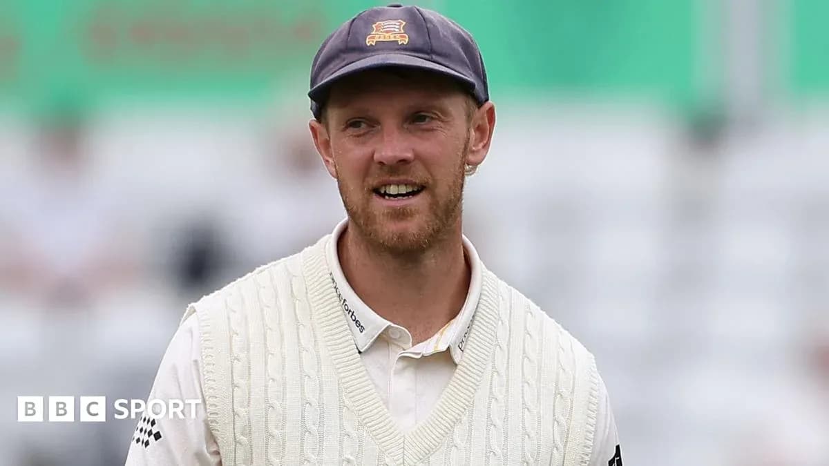 Cricketer wearing a sweater and cap on field Cricketer wearing a sweater and cap on field