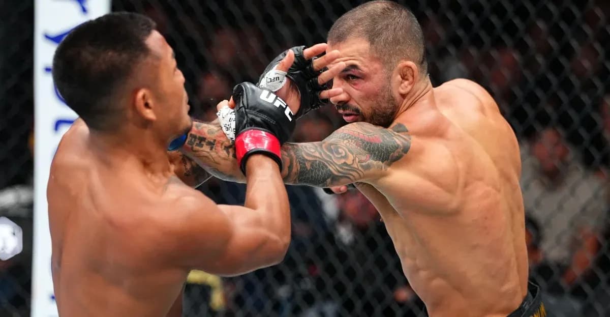 Two fighters exchanging punches in octagon Two fighters exchanging punches in octagon