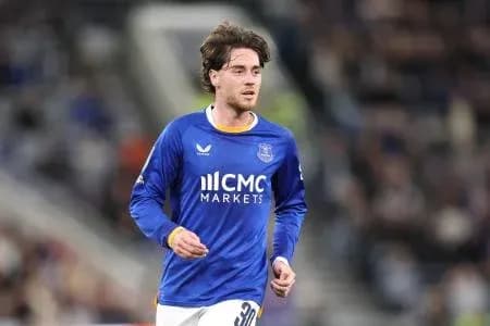 Player in blue jersey running on the pitch Player in blue jersey running on the pitch