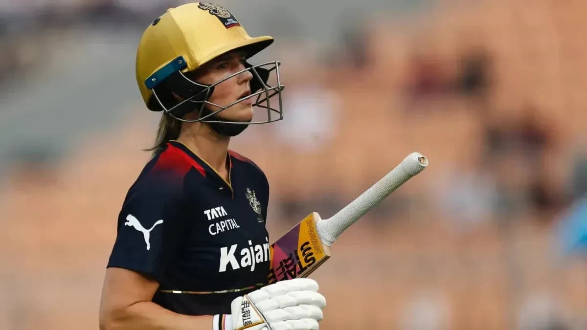 Cricketer in helmet holding bat on field Cricketer in helmet holding bat on field