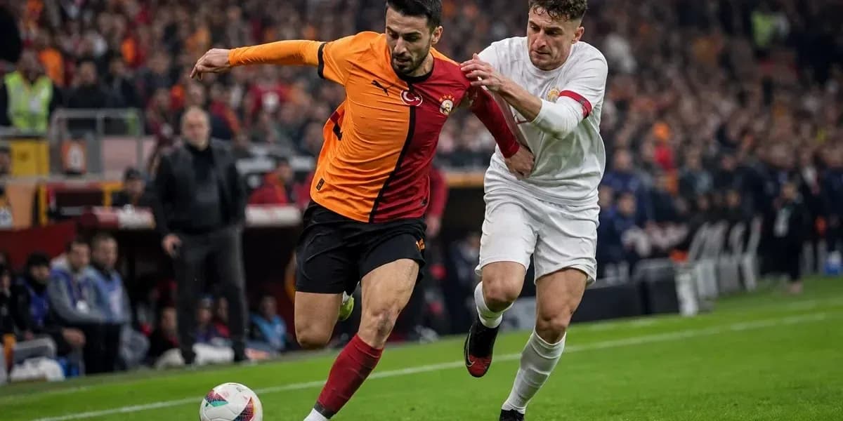 Player from Galatasaray being challenged by opponent Player from Galatasaray being challenged by opponent