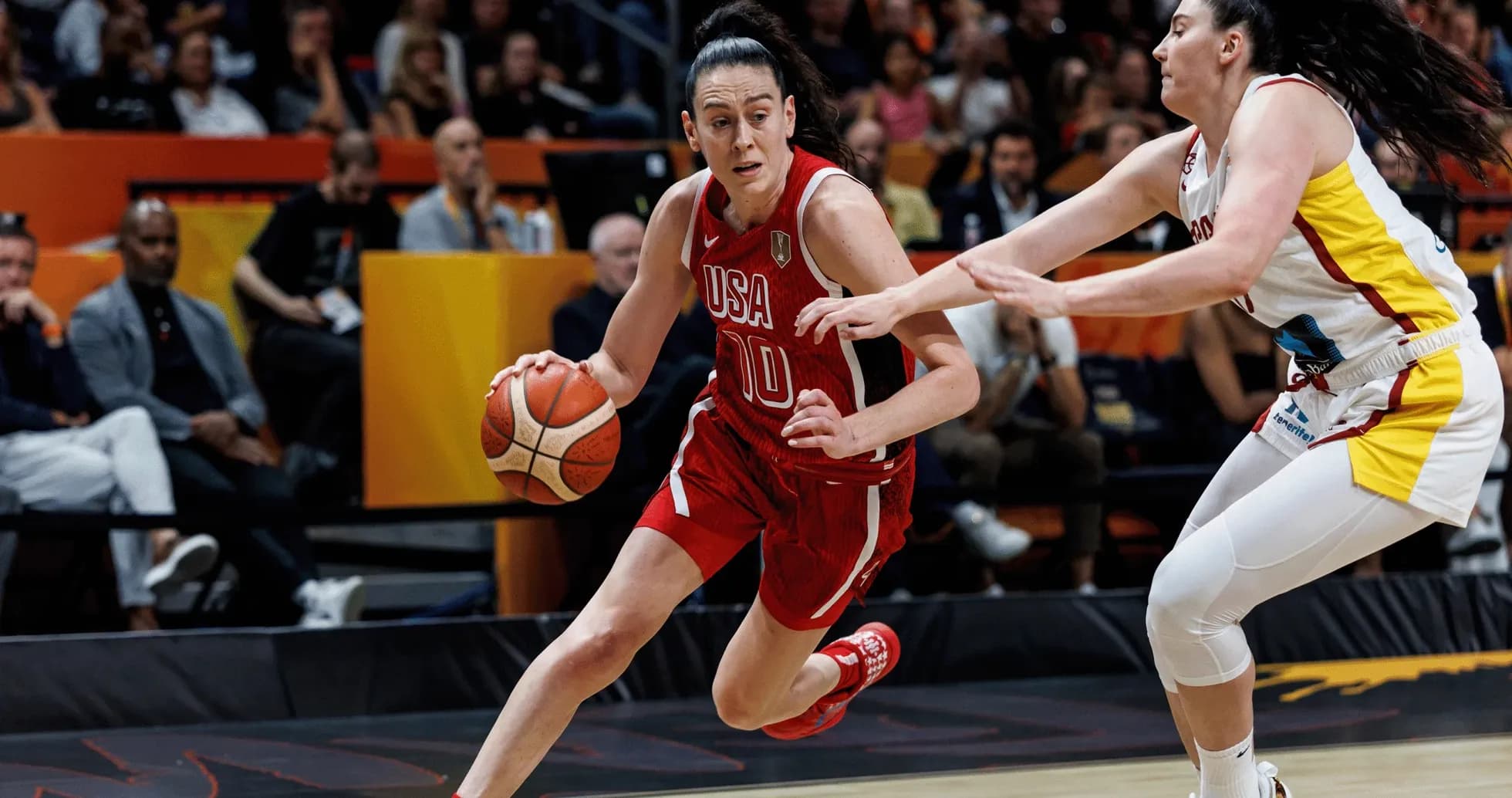 Player dribbling basketball while being defended Player dribbling basketball while being defended