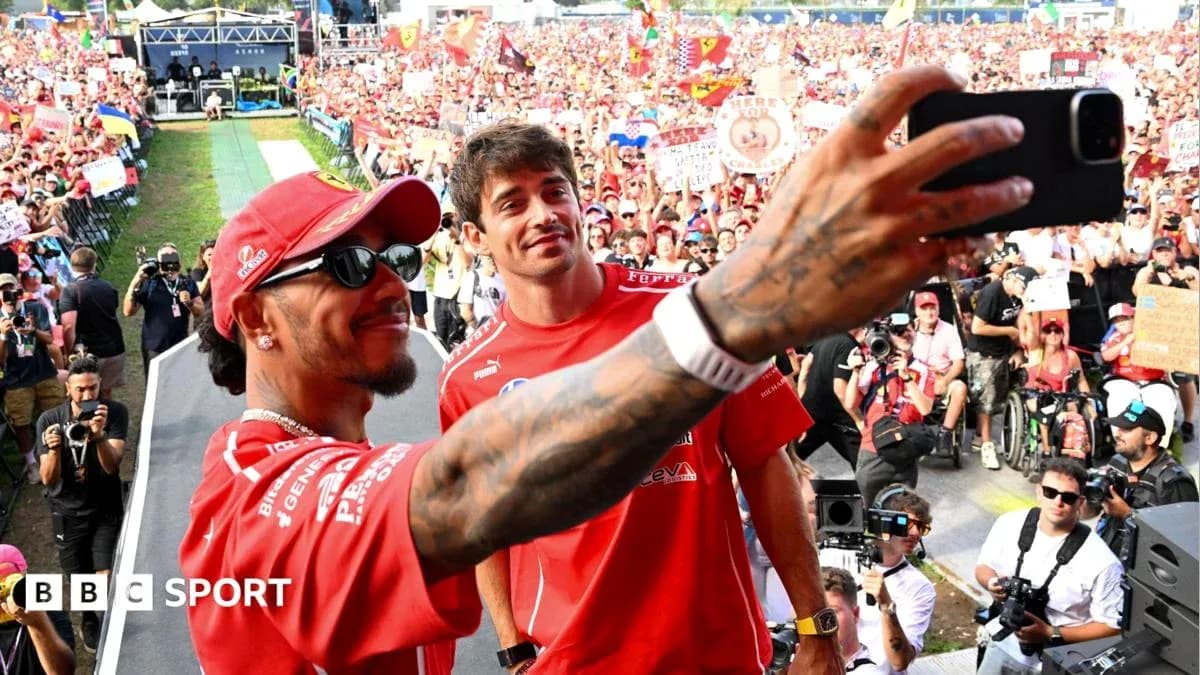Drivers taking selfie with fans in background Drivers taking selfie with fans in background