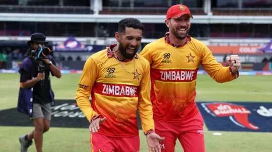 Two Zimbabwe players celebrating on the field Two Zimbabwe players celebrating on the field
