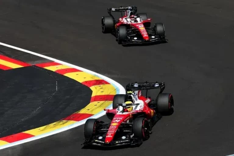 Two Ferrari cars racing on a curved track Two Ferrari cars racing on a curved track