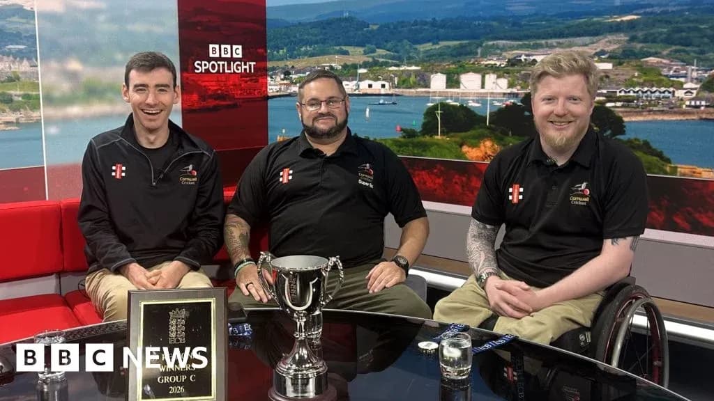 Three men celebrating with a trophy on set Three men celebrating with a trophy on set