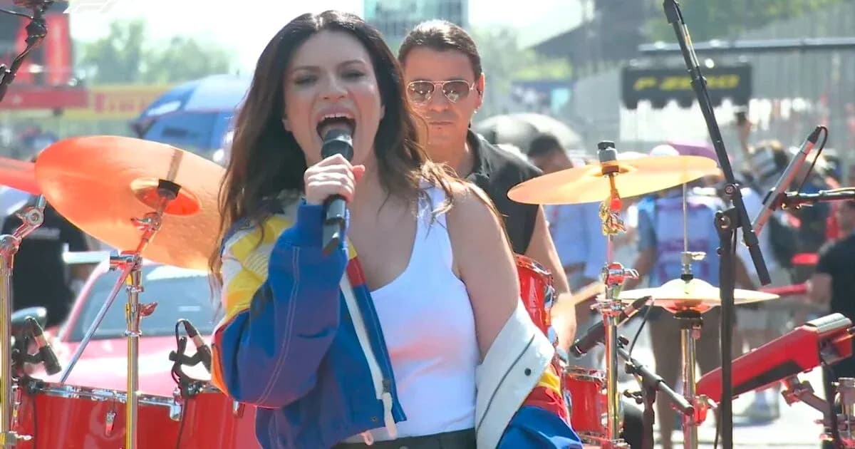 Singer performing with a band at outdoor event Singer performing with a band at outdoor event